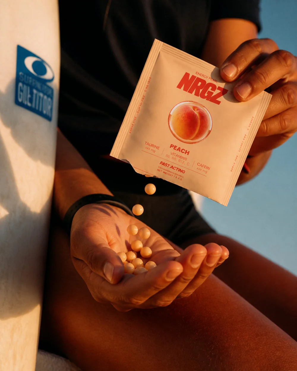 An athlete holding a peach NRGZ pack at the gym